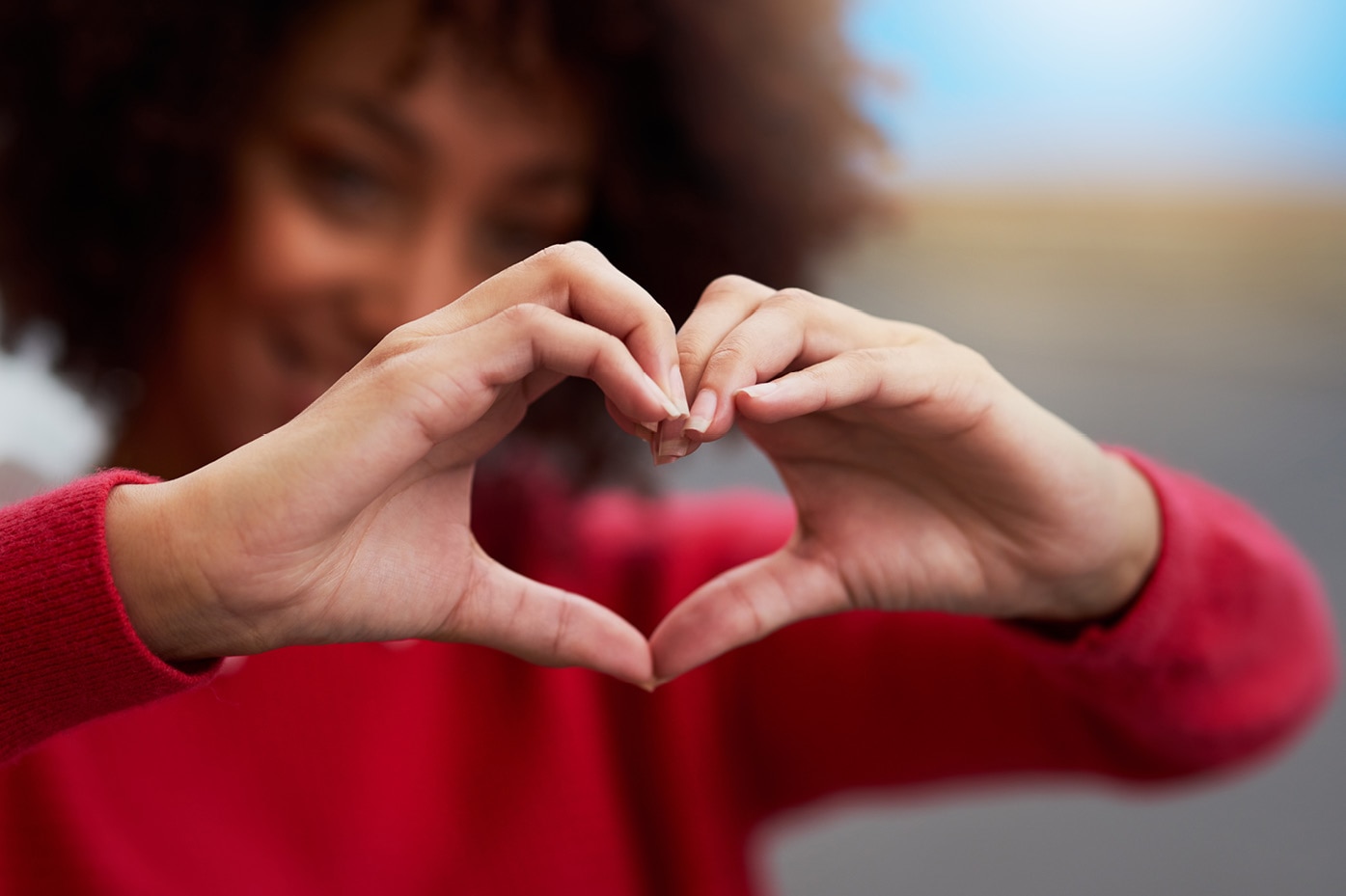 Person making a heart shape with their hands