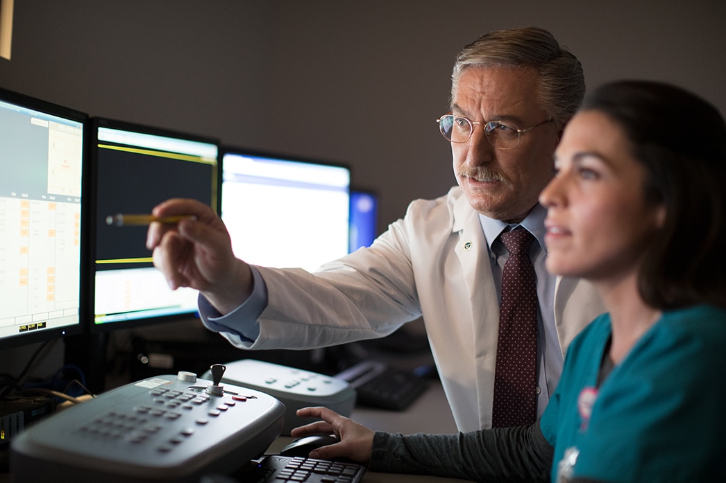 Two doctors reviewing MRI images on a monitor
