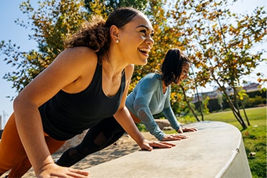 Two people exercising in the park