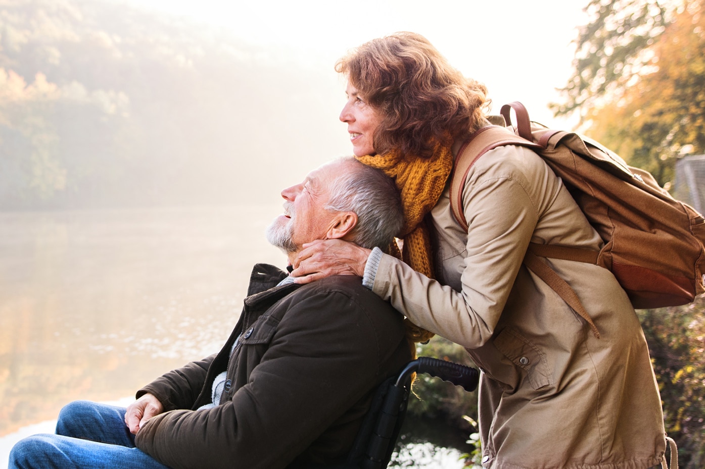 Two people leaning into each other and enjoying view of lake