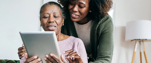Adult and parent hold tablet to review options online