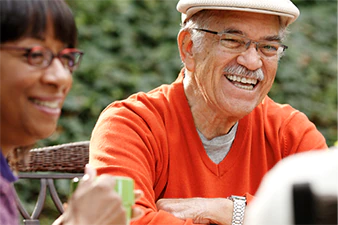 Smiling people sitting outside together