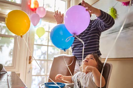 Person playing with balloons