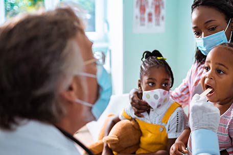 Parent and children visiting a doctor