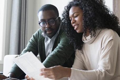 Two people reviewing paperwork at home