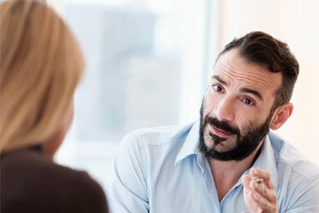 Two people talking about health plan costs