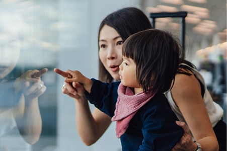  Parent and child looking through a store  window