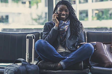  Person sitting in airport speaking on her phone