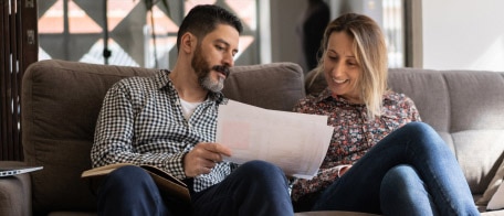 A couple reviewing paperwork at home.