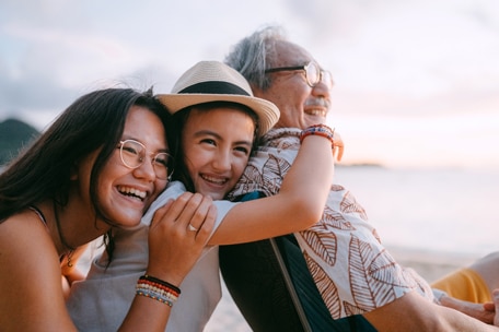 family-hugging-on-a-beach