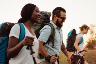 People wearing backpacks and hiking