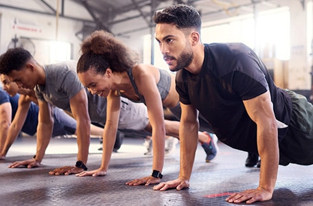 Person doing plank pose in group fitness class