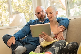 A couple holding each other while reading medical information