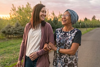 Two people walking and smiling