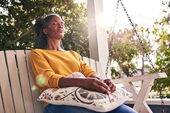 Person relaxing on a swing with eyes closed