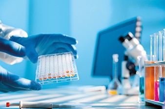 Researcher handling lab equipment