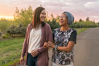 Two people walking and smiling