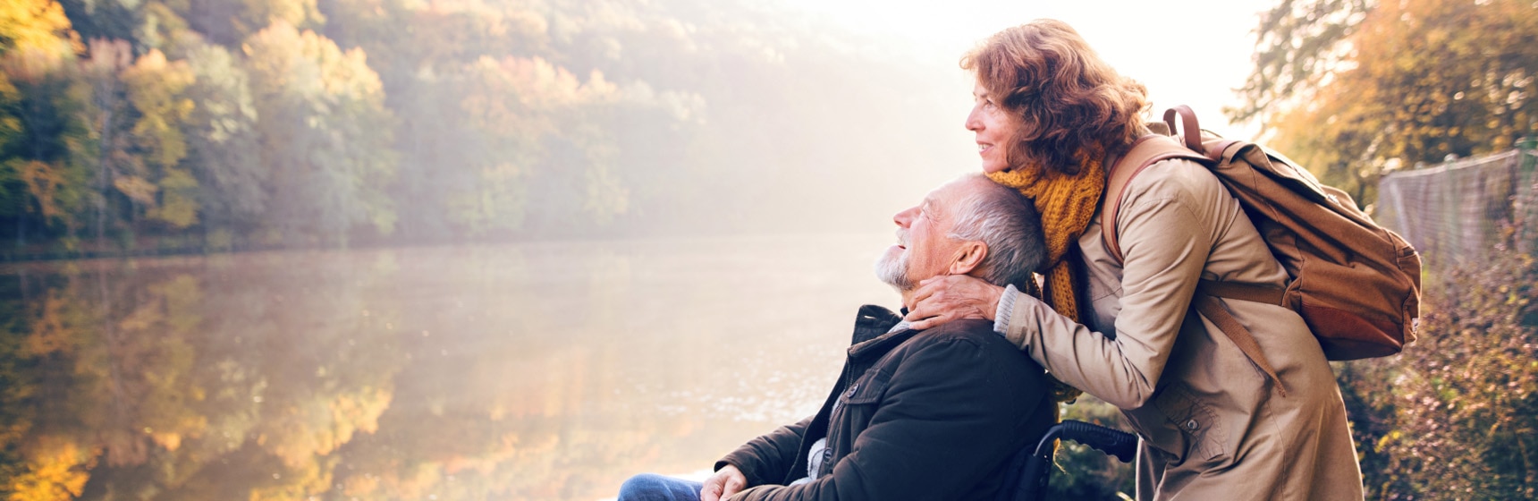 Person hugging parent by lake