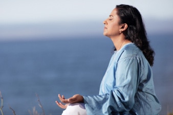 Person sitting and meditating outside