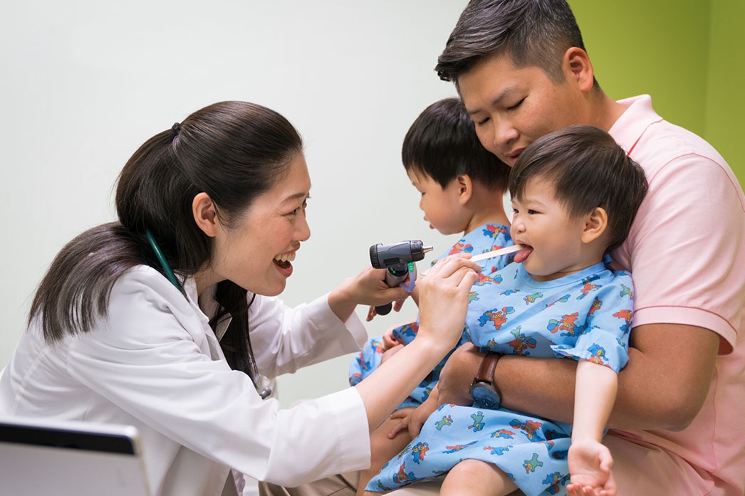 Pediatrician examining twins