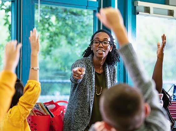 Teacher calling on a student who has their hand raised