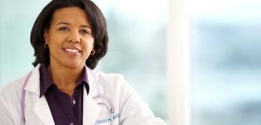 A female Kaiser Permanente doctor wearing a lab coat