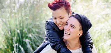 Young female couple smiling and hugging each other