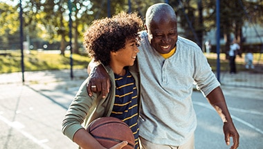 Grandparent embracing child with basketball