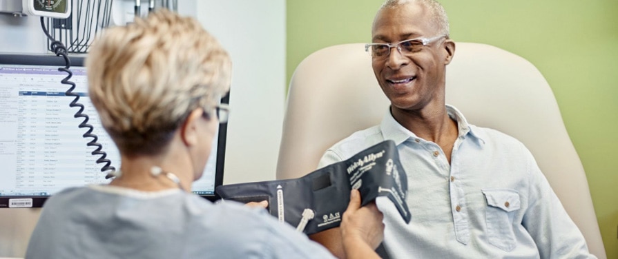 Patient getting his blood pressure taken Patient getting his blood pressure taken