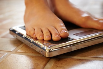 Person standing on a scale in bare feet