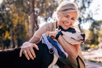 Person walking a dog outdoors on a path