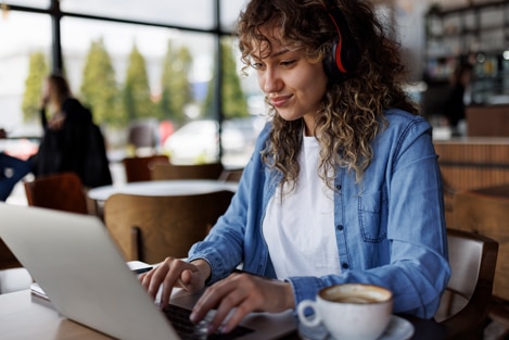 Person using a laptop in a coffee shop