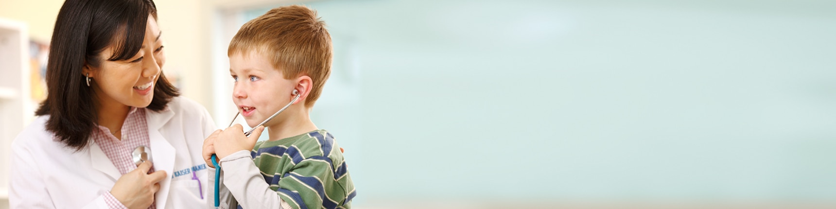 child trying out his pediatrician's stethoscope