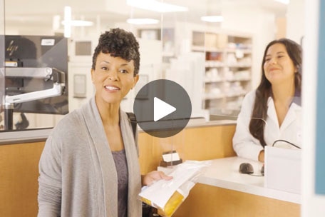 Person at pharmacy discussing medications