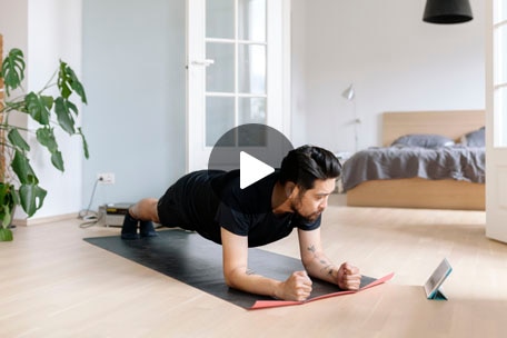 Person doing pushups on an exercise mat