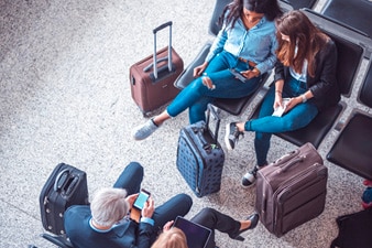 Two people in a waiting area looking at a mobile device