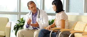 Doctor speaking to patient in a waiting room