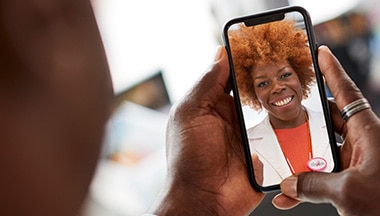 Person having a video visit with their doctor on a smartphone