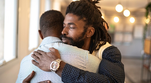 Two people comforting each other
