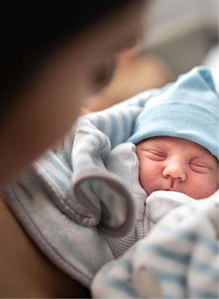 Parent holding their newborn baby