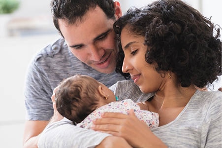 Parents at home with their baby