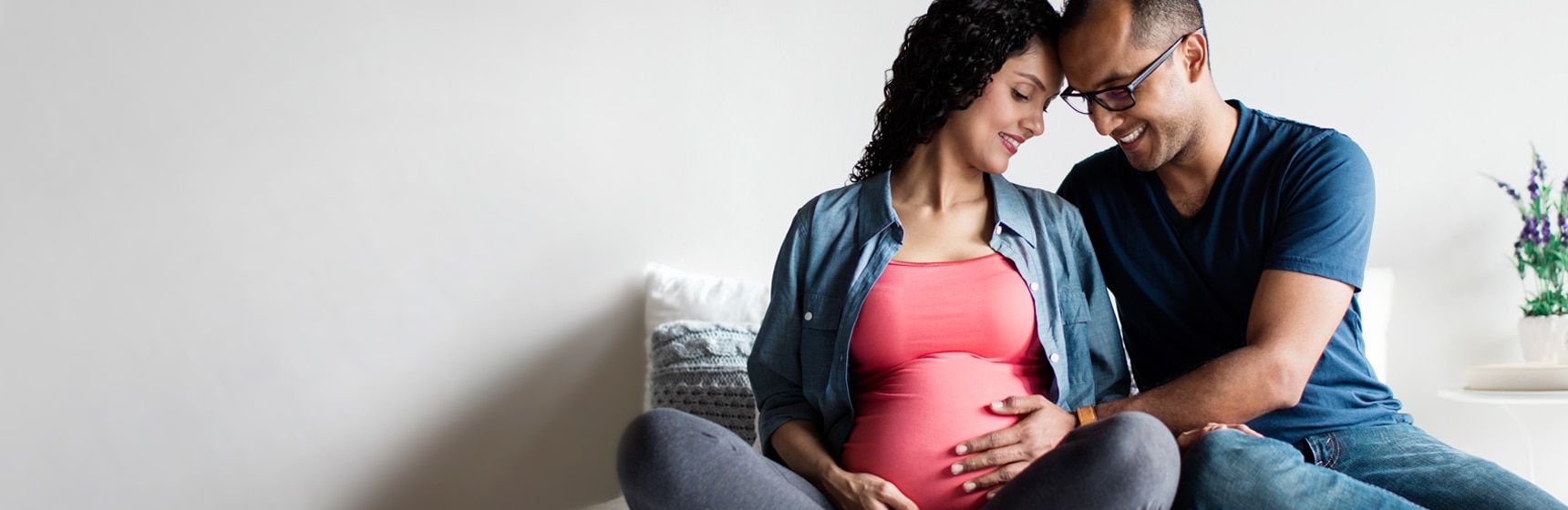 Partner touching pregnant person's stomach