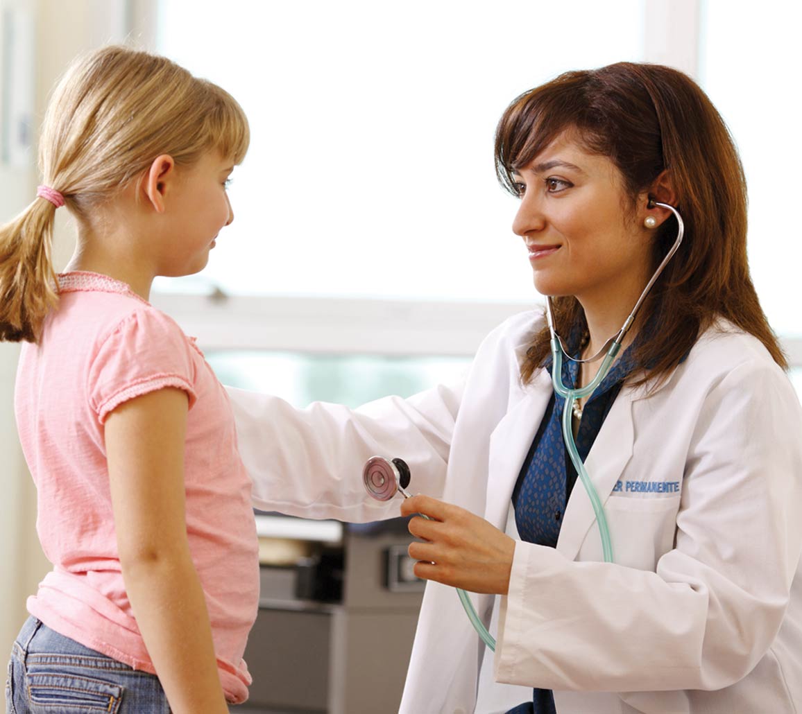 A smiling member visiting their doctor