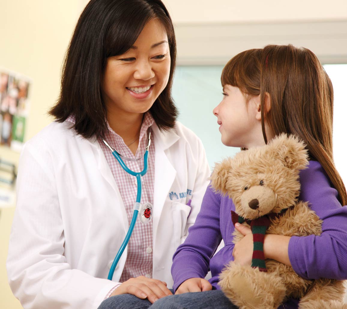 A smiling member visiting their doctor