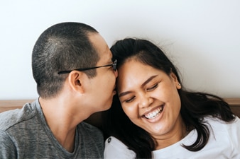 Person kissing their partner’s forehead