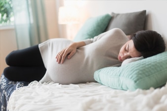 Pregnant person taking a nap