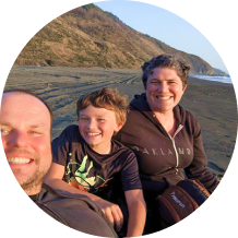 Family smiling while at the beach