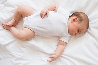 Baby sleeping on blanket.