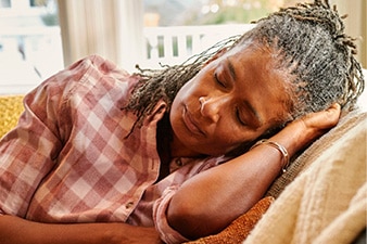 Person napping on a chair.