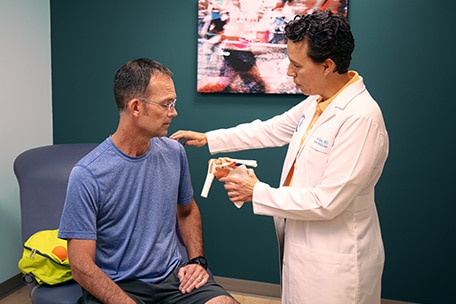 Doctor examining patient’s shoulder